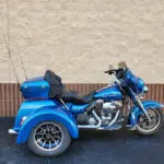 A blue motorcycle parked in front of a building.