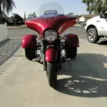 A red motorcycle parked on the side of a road.