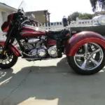 A red motorcycle parked on the side of a road.