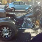 A motorcycle with a side car parked in the street.