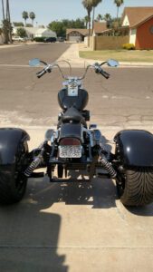 matte black trike on road