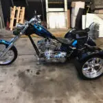 A blue and black motorcycle parked in a garage.