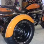 A motorcycle with orange paint on the front tire.