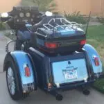 A motorcycle with two side cars parked on the street.