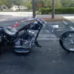 A motorcycle parked in the parking lot of a building.