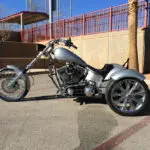 A motorcycle parked in the parking lot of a building.