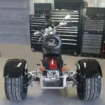 A three wheeled motorcycle with tires on the back.