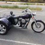 A motorcycle with a side car parked in the street.