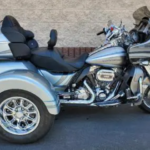 A motorcycle with three wheels parked in front of a building.