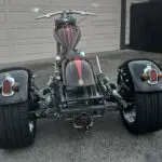 A three wheeled motorcycle parked in the street.