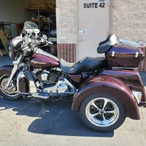 A motorcycle with a side car parked in front of a building.