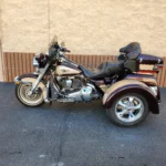 A motorcycle with a side car parked in the street.