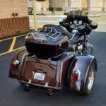 A motorcycle with a side car parked in the street.