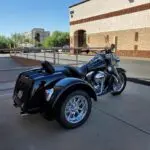 A motorcycle with a side car parked in front of a building.