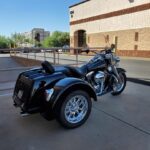 A motorcycle with a side car parked in front of a building.