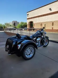 A motorcycle with a side car parked in front of a building.